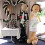 Calderfields- Our 'Happy Couple' Bride and Groom pose by the cake table and Heart Sculpture. Decor by Huff, Puff and Away!