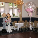 Bride and Groom Character Greeters, with 3-balloon Clusters in the stunning combination of pearl ivory, pearl pink and chocolate inside a 'Just Married Around' clear balloon. The 'Studley Bubble' incorporates the same colour scheme. Character Greeters and decor by Huff, Puff and Away!
