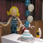 A Party Girl with a 5-balloon Cluster in pearl teal blue and pearl white