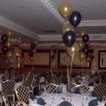 5-balloon Clusters in gold and black, the gold balloons being printed with 2 different designs. The Queen Hotel, Chester, balloon decor by Huff, Puff and Away! 5-balloon Clusters in gold and black, the gold balloons being printed with 2 different designs. The Queen Hotel, Chester, balloon decor by Huff, Puff and Away!